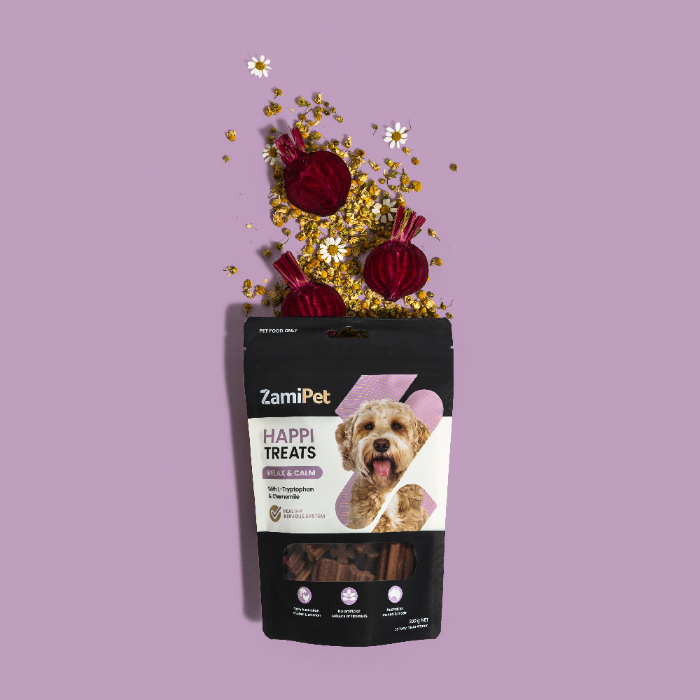 A front view of a pack of ZamiPet HappiTreats Relax & Calm, wiht dried chamomile flowers and cross sections of beetroot coming out of the top (key ingredients in the product), over a purple background